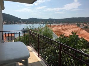 a balcony with a view of a body of water at Apartment Kustura in Vinišće