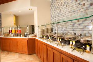 a kitchen with a counter with many pots and pans at DoubleTree Suites by Hilton Raleigh-Durham in Durham