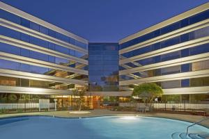 a large building with a swimming pool in front of it at Hilton Durham near Duke University in Durham