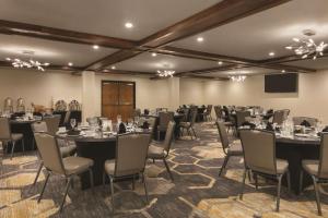 a conference room with tables and chairs and a podium at Embassy Suites by Hilton Richmond in Richmond