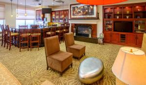 a large room with a bar and a dining room at Hilton Garden Inn Rochester Downtown in Rochester