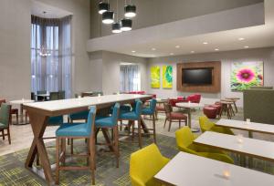 a restaurant with tables and chairs and a flat screen tv at Hampton Inn & Suites Rockport-Fulton in Rockport