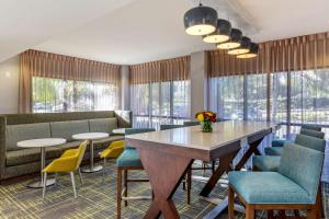 a lobby with a table and chairs and windows at Hampton Inn Carlsbad North San Diego County in Carlsbad
