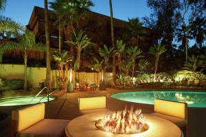 a fire pit in front of a swimming pool at DoubleTree By Hilton San Diego Hotel Circle in San Diego