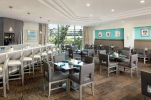 a restaurant with tables and chairs and a bar at DoubleTree By Hilton San Diego Hotel Circle in San Diego