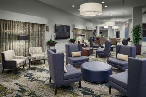 a waiting area in a hospital with chairs and tables at DoubleTree by Hilton San Antonio Downtown in San Antonio