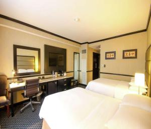 Postel nebo postele na pokoji v ubytování Hilton Princess San Pedro Sula