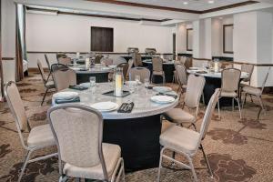 a conference room with tables and chairs and a podium at Hilton Garden Inn San Antonio Airport in San Antonio +26 photos