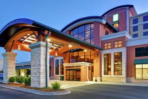 a large building with an archway in front of it at Embassy Suites Savannah Airport in Savannah