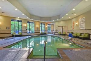 a large swimming pool in a hotel room at Embassy Suites Savannah Airport in Savannah