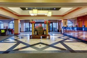 a lobby with a fountain in the middle of a building at Embassy Suites by Hilton Louisville East in Louisville