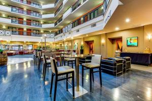 a restaurant with chairs and tables in a building at Embassy Suites by Hilton Louisville East in Louisville