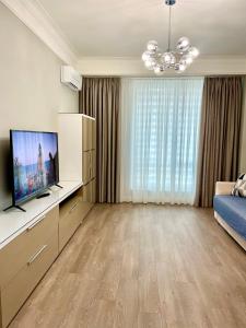 a living room with a television and a couch at Marius Home in Chişinău