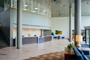 a lobby of a building with columns and a waiting area at DoubleTree by Hilton Hotel South Bend in South Bend