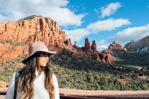 a woman wearing a hat standing in front of a mountain at Hilton Sedona Resort at Bell Rock in Sedona