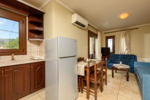 a kitchen and dining room with a refrigerator and a table at Villa Angel in Limenas +21 photos