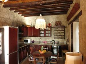 a kitchen with a table with a bowl of fruit on it at Simona Stone House in Polis Chrysochous