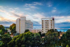 a tall white building with a sign on top of it at DoubleTree by Hilton San Francisco Airport in Burlingame