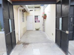 um corredor vazio de um edifício com portas pretas em COZY Fully equipped private apartment em Chimaltenango