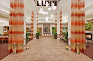 a lobby of a hotel with columns and tables at Hilton Garden Inn San Francisco Airport North in South San Francisco