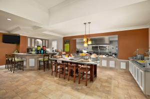 a kitchen and dining room with a table and chairs at Hilton Garden Inn San Francisco Airport North in South San Francisco