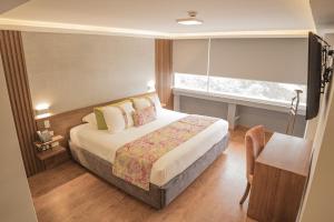 Postel nebo postele na pokoji v ubytování Hotel Ambato + 30 fotografií