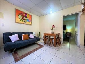 a living room with a blue couch and a table at COZY Fully equipped private apartment in Chimaltenango