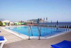 a swimming pool with a view of the ocean at Hotel Royal in Alanya
