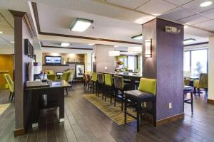 a restaurant with chairs and a bar in a room at Hampton Inn Salina in Salina