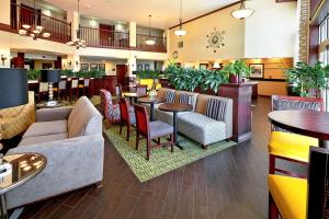 a lobby of a hotel with tables and chairs at Hampton Inn Salt Lake City Central in Salt Lake City