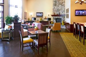 a restaurant with tables and chairs and a fireplace at Hampton Inn Salt Lake City Central in Salt Lake City