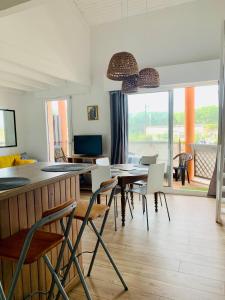 a dining room with a table and chairs at - Appartement Cauris - in Vieux-Boucau-les-Bains