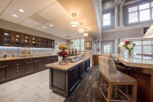 a large kitchen with a large center island with bar stools at Homewood Suites by Hilton Olmsted Village in Pinehurst