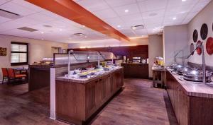 a restaurant kitchen with a buffet line with food at Hilton Saint John in Saint John