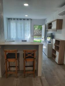 a kitchen with two chairs and a island in a kitchen at CASA VACACIONAL INDIVIDUAL 65mtr in Pinto
