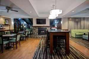 a restaurant with a bar and a fireplace at Hampton Inn West Springfield in West Springfield