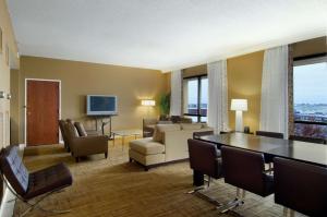 a living room with a couch and a table and chairs at Hilton St. Louis Airport in Woodson Terrace