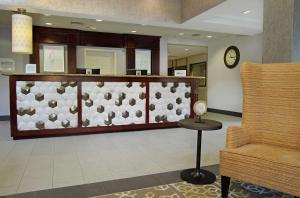 a lobby with a reception counter and a chair at Hilton Garden Inn Sonoma County Airport in Santa Rosa