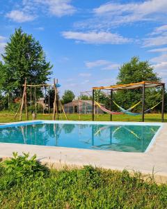 an empty swimming pool with a swing set in a park at Agapia Agapescu in Agapia