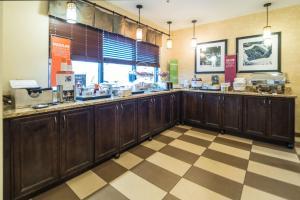 a restaurant counter with wooden cabinets and a checkered floor at Hampton Inn Tiffin in Tiffin