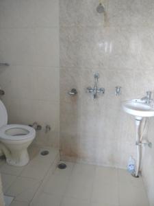 a bathroom with a toilet and a sink at Shri Homes in Varanasi
