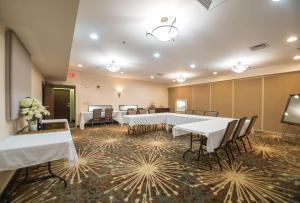 a conference room with tables and chairs and flowers on the floor at Hampton Inn Tiffin in Tiffin