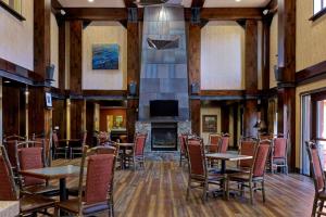 a dining room with tables and chairs and a fireplace at Hampton Inn & Suites Tahoe-Truckee in Truckee