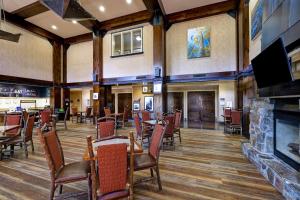 a restaurant with tables and chairs and a fireplace at Hampton Inn & Suites Tahoe-Truckee in Truckee