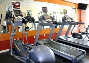 a gym with several tread machines in a room at Hilton Garden Inn Tampa North in Tampa