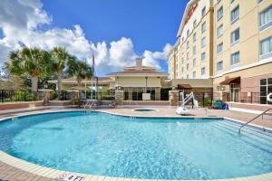a large swimming pool in front of a hotel at Hilton Garden Inn Tampa Riverview Brandon in Brandon