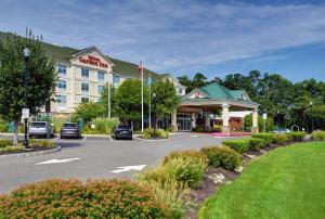 a hotel with cars parked in a parking lot at Hilton Garden Inn Hamilton in Bordentown