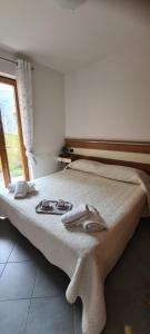 a bedroom with a bed with towels on it at Casa Vacanza Glicine in Parzanica +32 photos