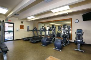 a gym with several tread machines and a mirror at DoubleTree Suites by Hilton Tucson Airport in Tucson +25 photos