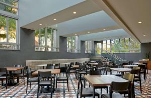 a dining room with tables and chairs and windows at Embassy Suites by Hilton Washington DC Convention Center in Washington